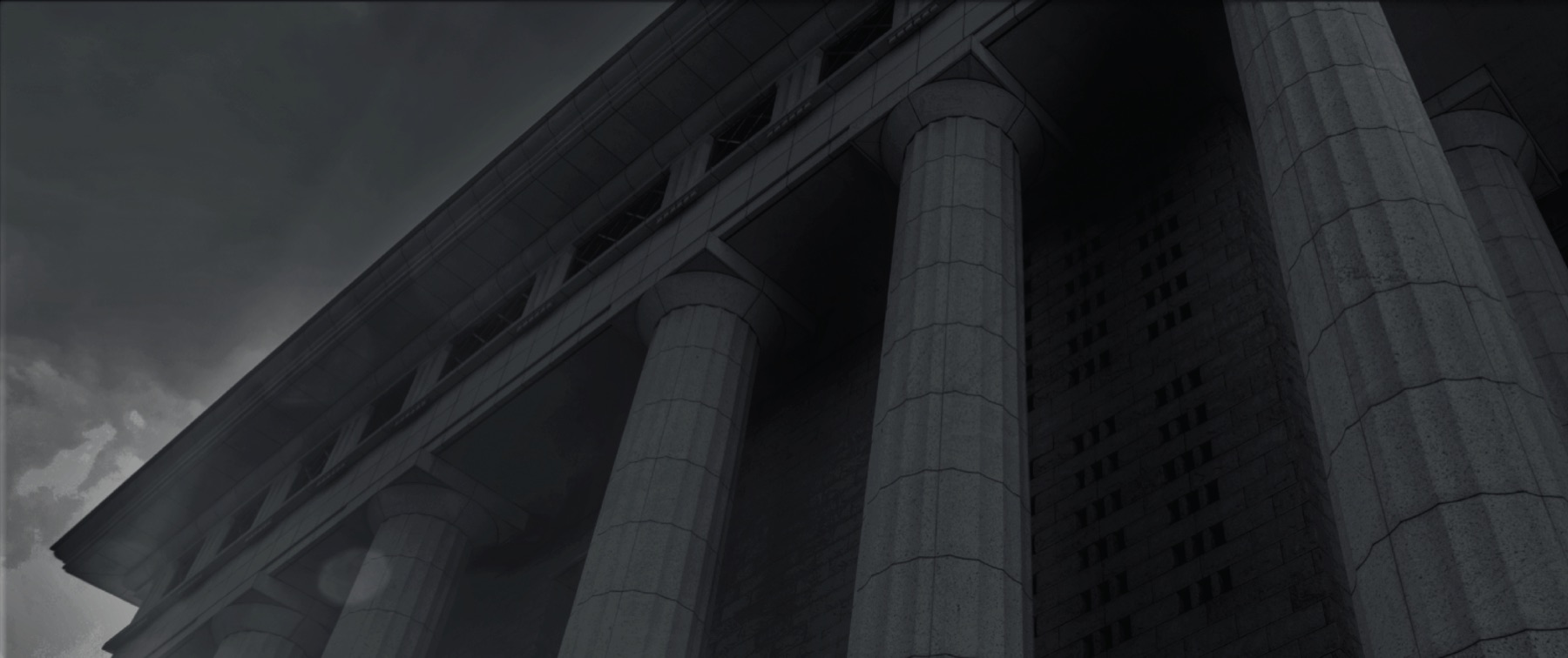 Stone columns of an institutional building against the sky