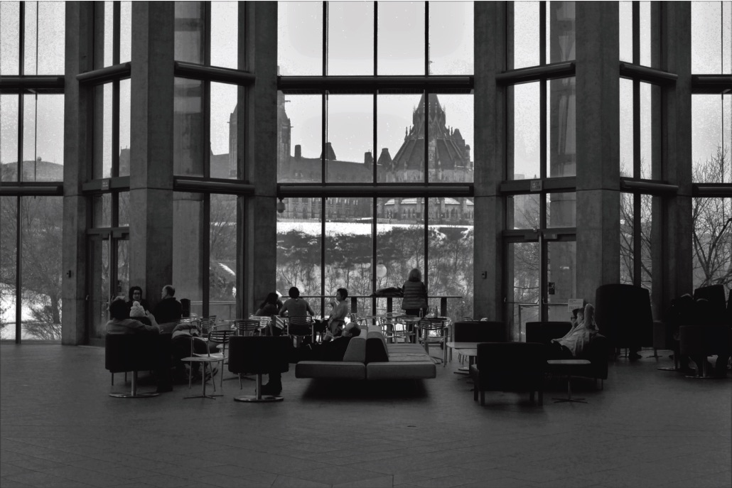 People meeting in the great hall of an institutional building